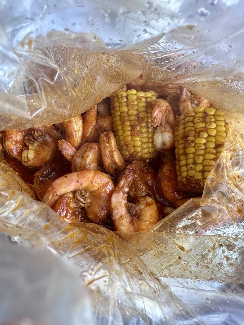 Cajun plates with crab, shrimp, and sides.